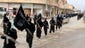 This undated image posted on a militant website on Jan. 14 shows fighters from the al-Qaeda-linked Islamic State of Iraq and the Levant marching in Raqqa, Syria.