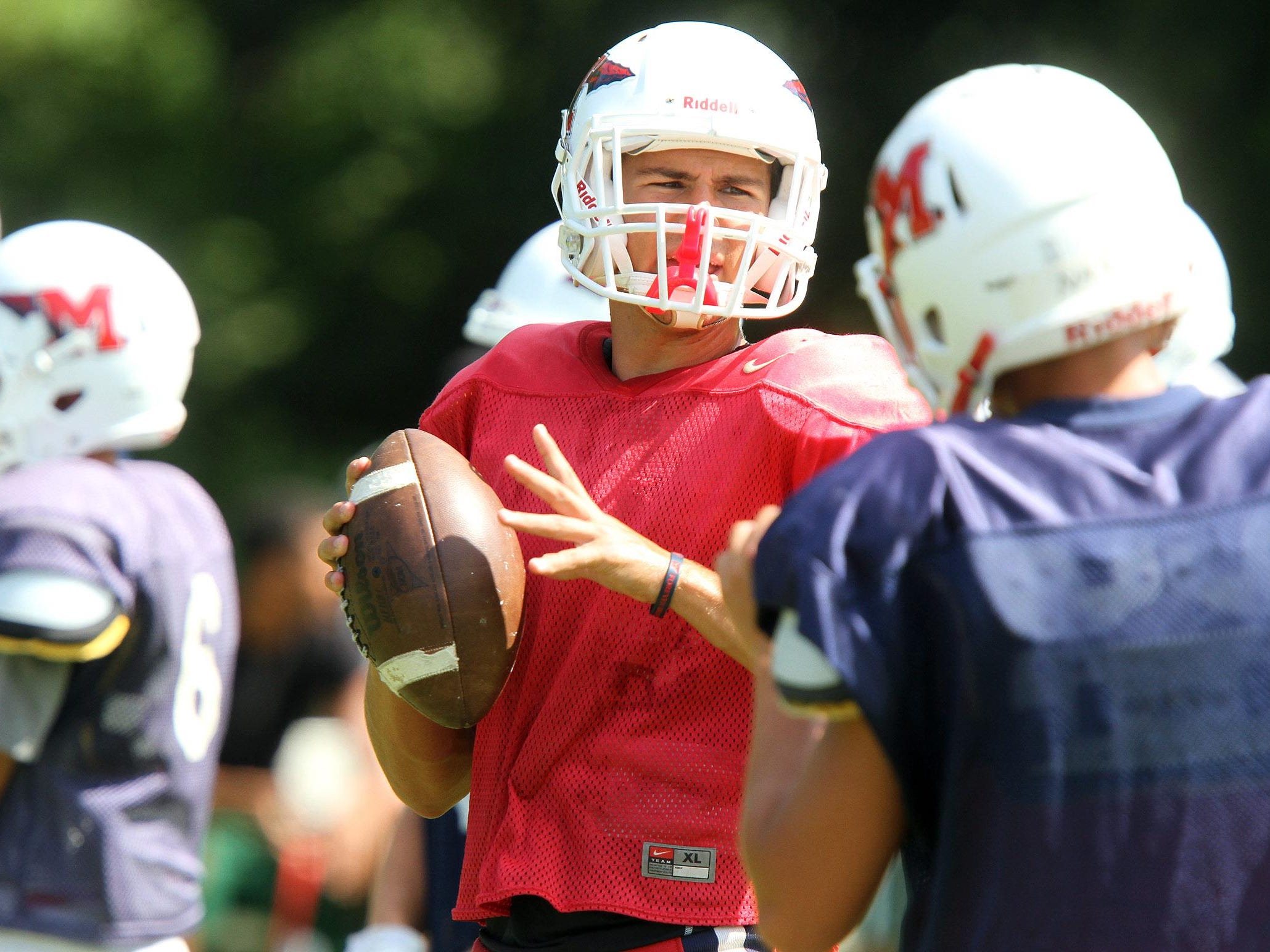 Manalapan Quarterback Luke Corcione runs drills with his team mates during a scrimmage with Colts Neck at home Thursday, August 27, 2015.