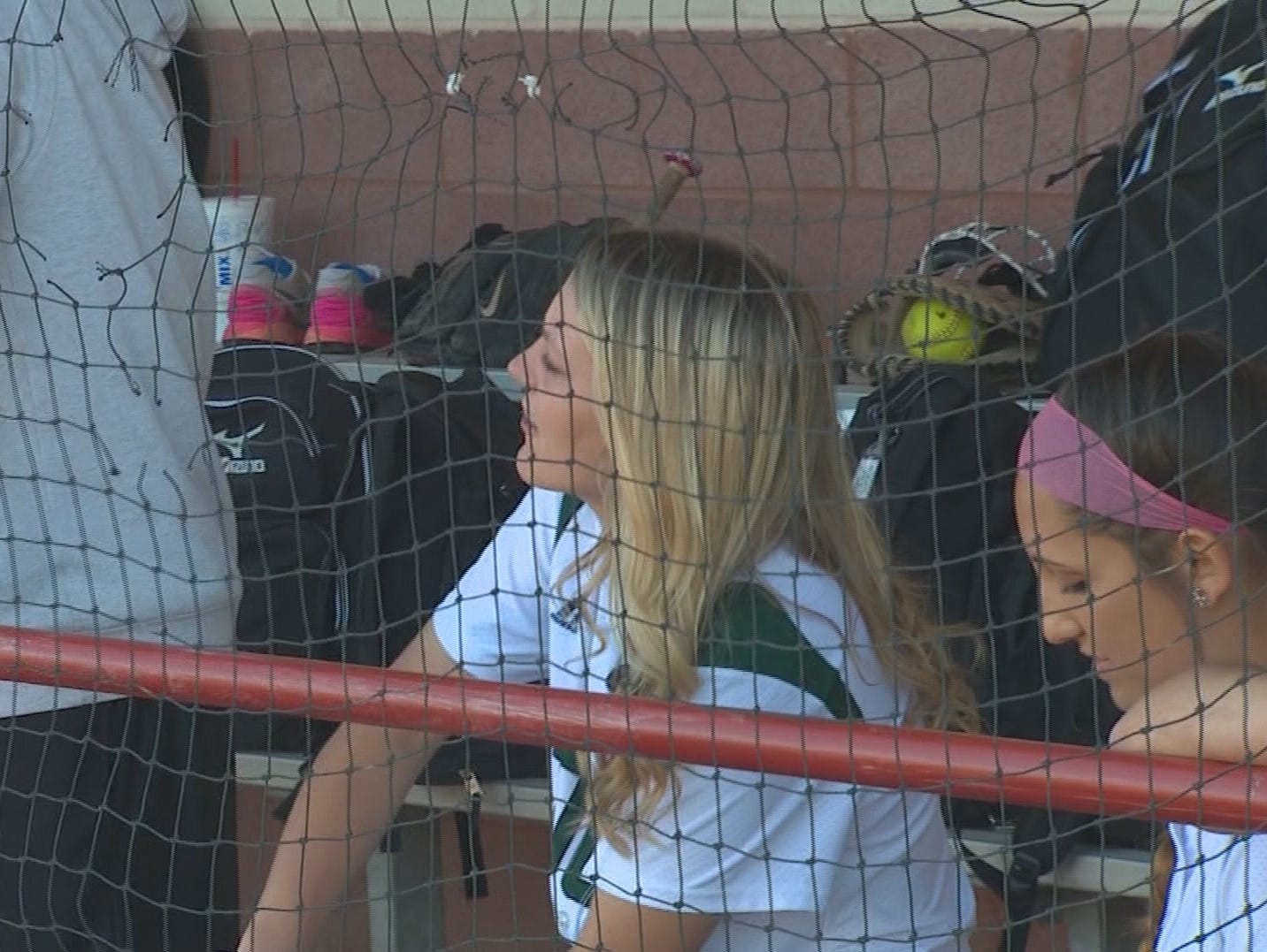 Hallie Crossnoe cheers her teammates on from the dugout