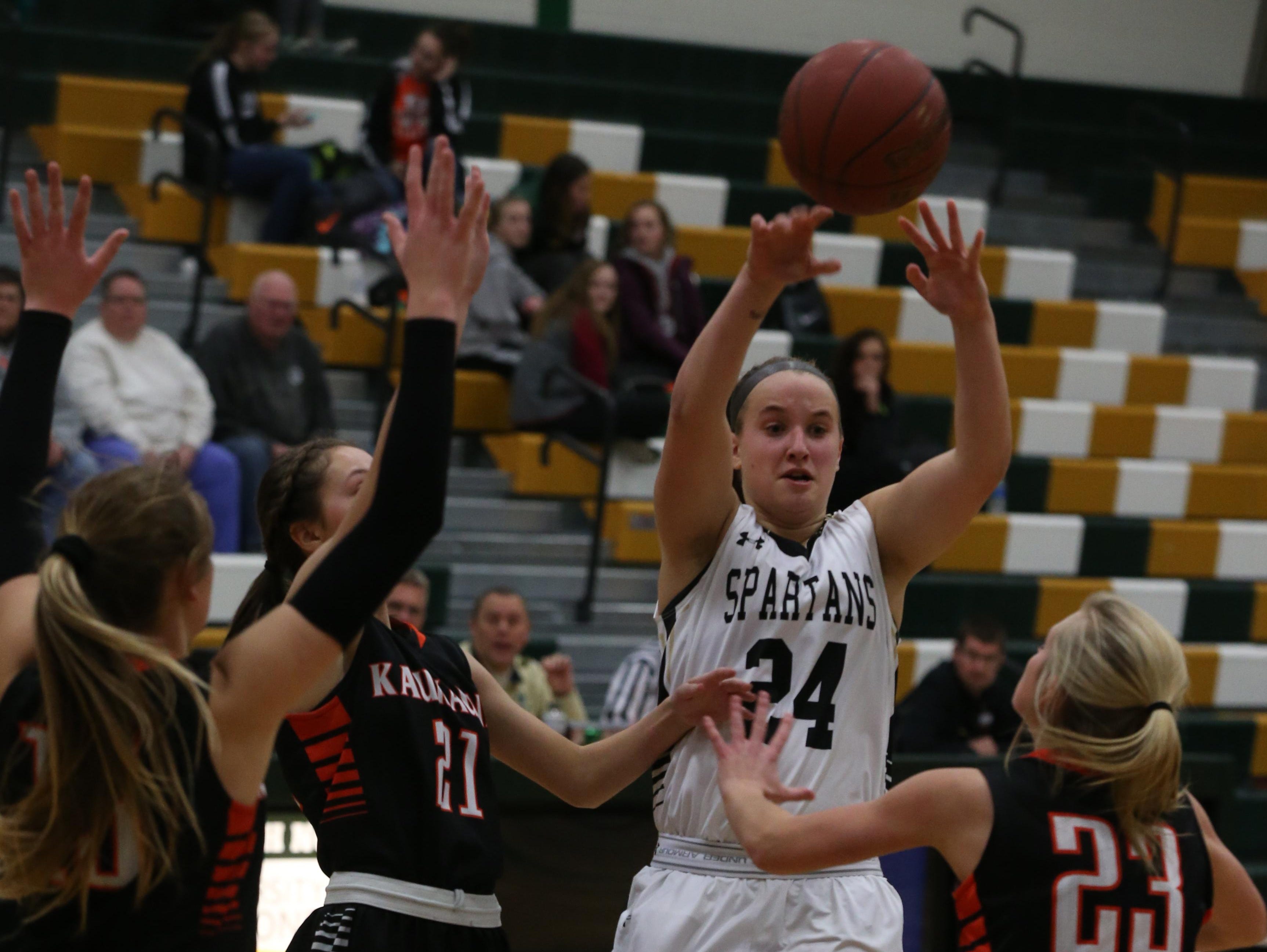 Oshkosh North’s Kaylee Anthes (24) makes a pass over Kaukauna defenders on Thursday.