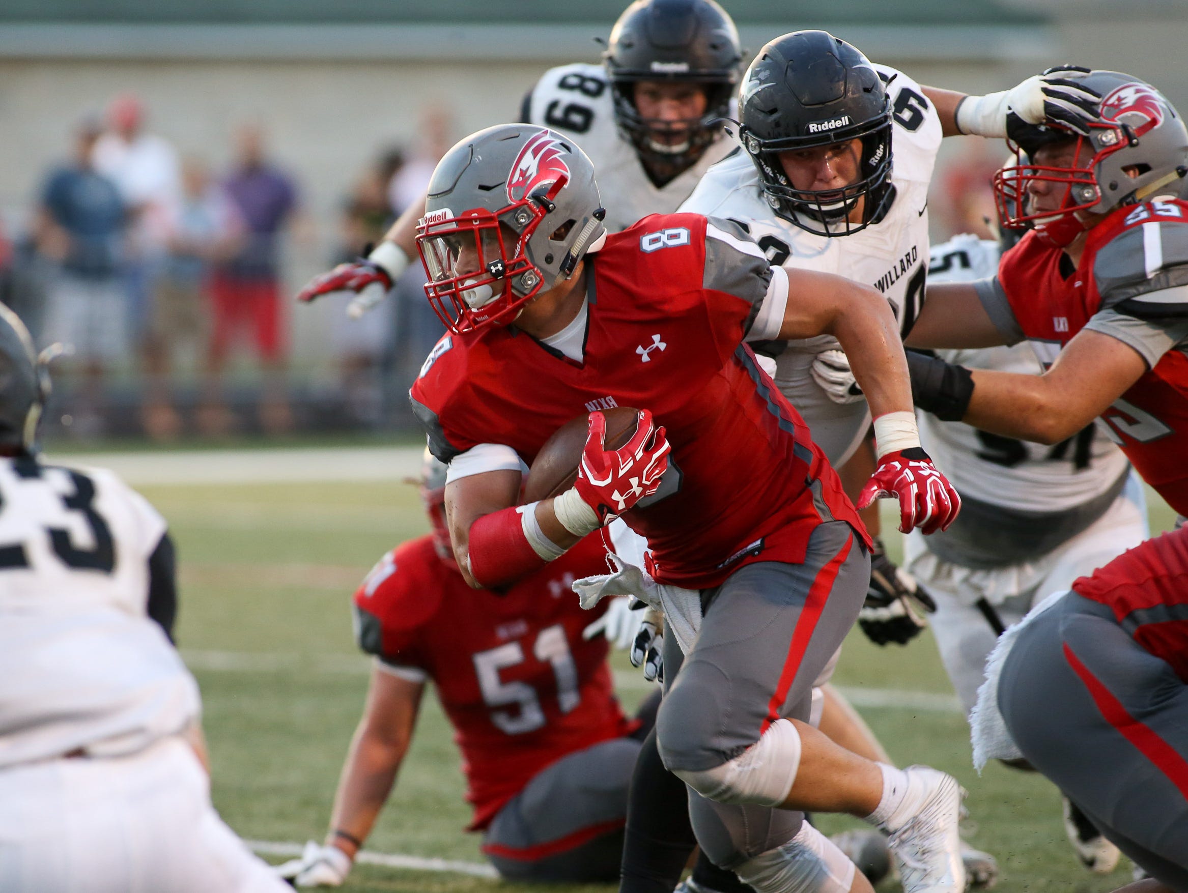 Nixa High School's Hayden Young tries to get away from Willard High School's defense Friday, August 19, 2016. Jason Connel / For the News-Leader