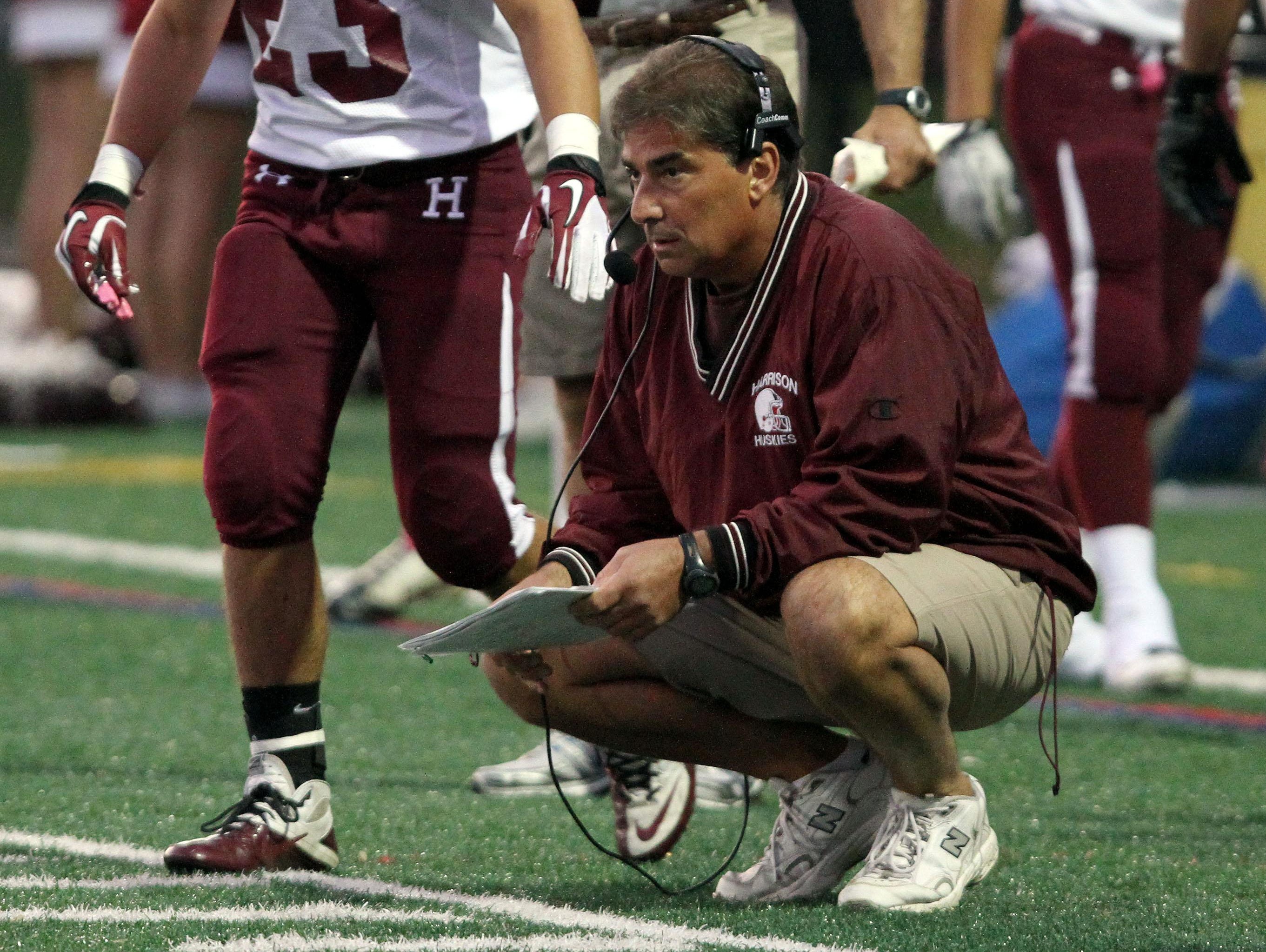 Former Harrison football coach Art Troilo Jr. is shown coaching during a 2011 game against Ossining at Ossining High School.