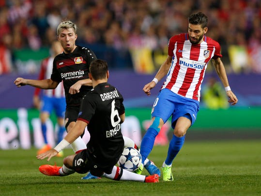 Atletico's Yannick Carrasco, right, is blocked by Leverkusen's Aleksandar Dragovic during the Champions League round of 16 second leg soccer match between Atletico Madrid and Bayer Leverkusen at the Vicente Calderon stadium in Madrid, Spain, Wednesday, March 15, 2017. (AP Photo/Daniel Ochoa de Olza)