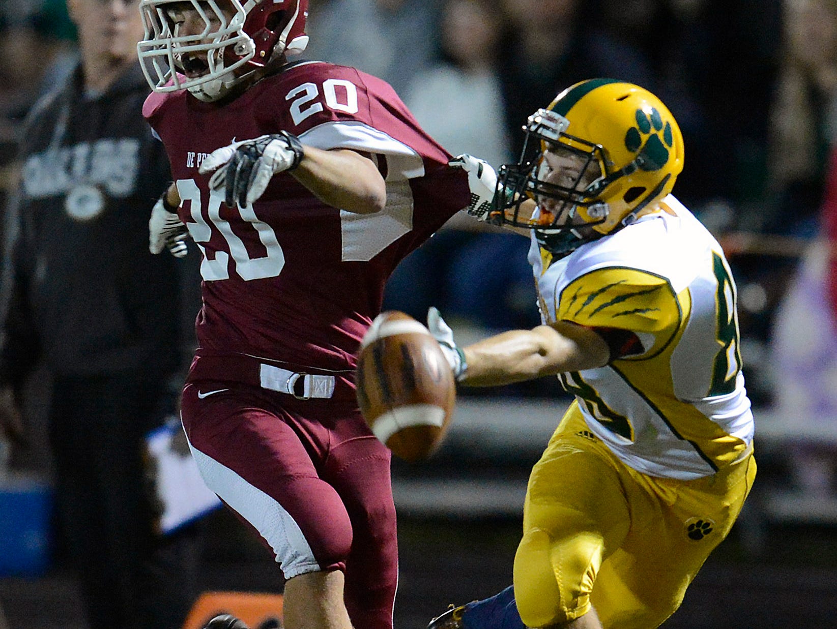 Ashwaubenon receiver Nathan Holly (88) tries to make a catch past De Pere cornerback Connor Kupsh (20) during Friday night's football game in De Pere. Kupsh was called for pass interference on the play.