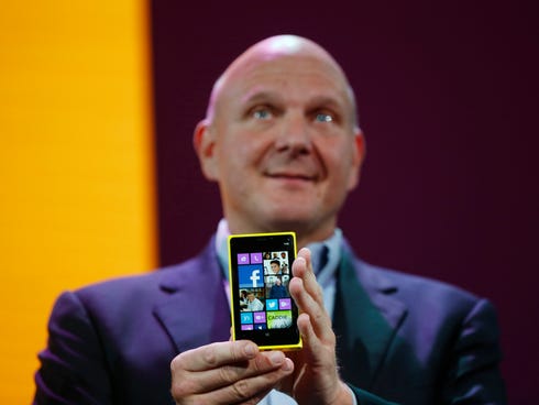 Microsoft CEO Steve Ballmer holds a Nokia Lumia 920 smartphone during a Windows Phone 8 launch event in October 2012.