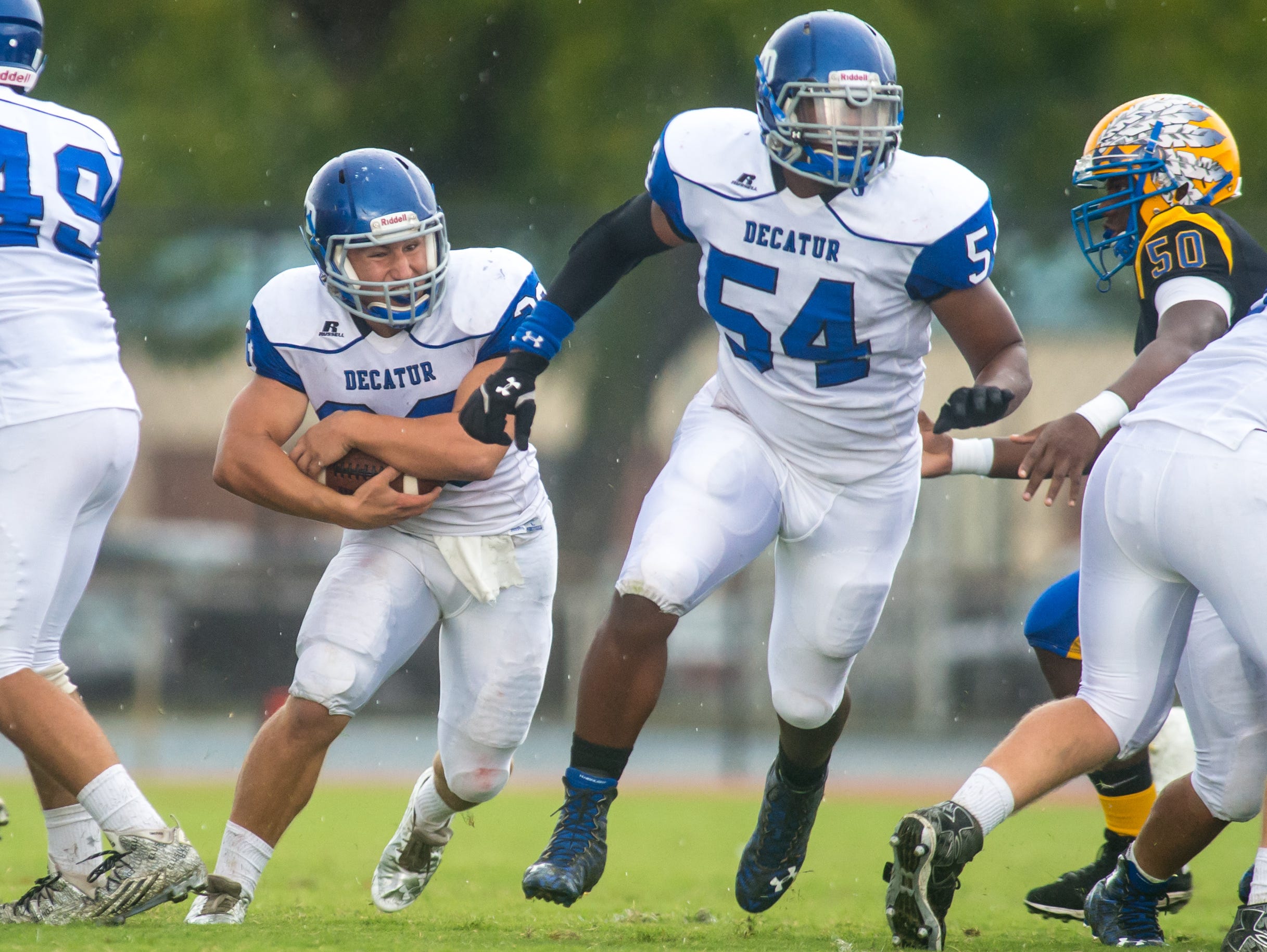 Stephen Decatur left tackle Ernest Shockley (54) clears a hole for running back Dryden Brous (33) against Wicomico High on Saturday afternoon at Wicomico County Stadium.