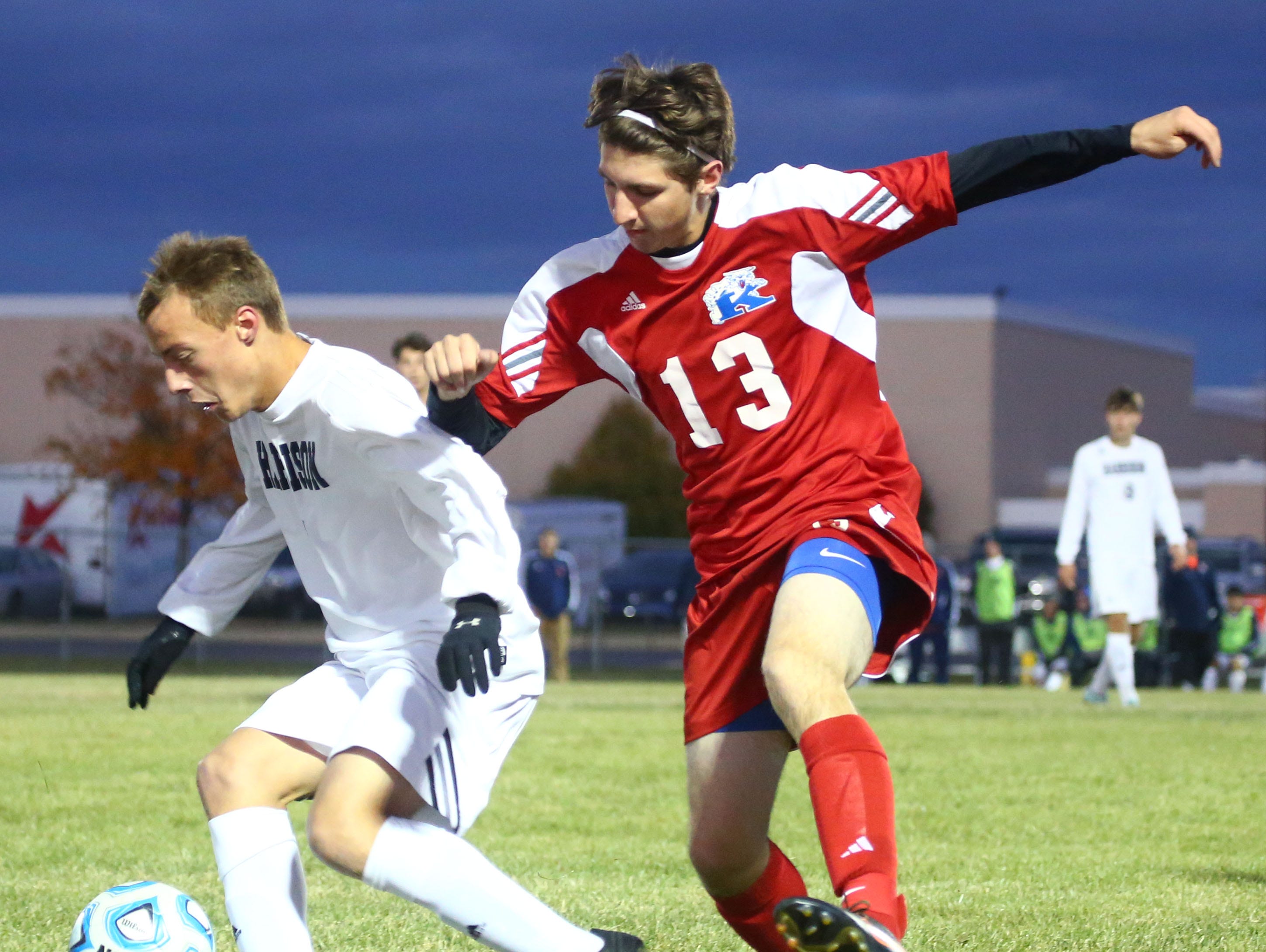 Harrison's Daniel Madren and Kokomo's Robert Martin compete for the ball.