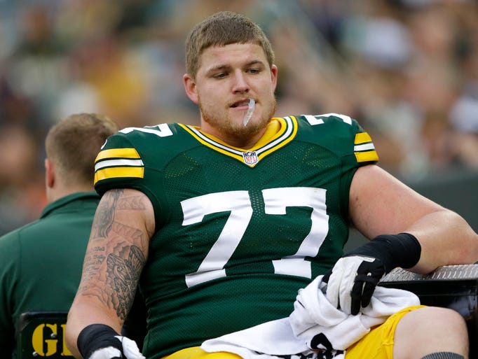 Green Bay Packers' Aaron Adams is carted off the field after getting injured in the first quarter.