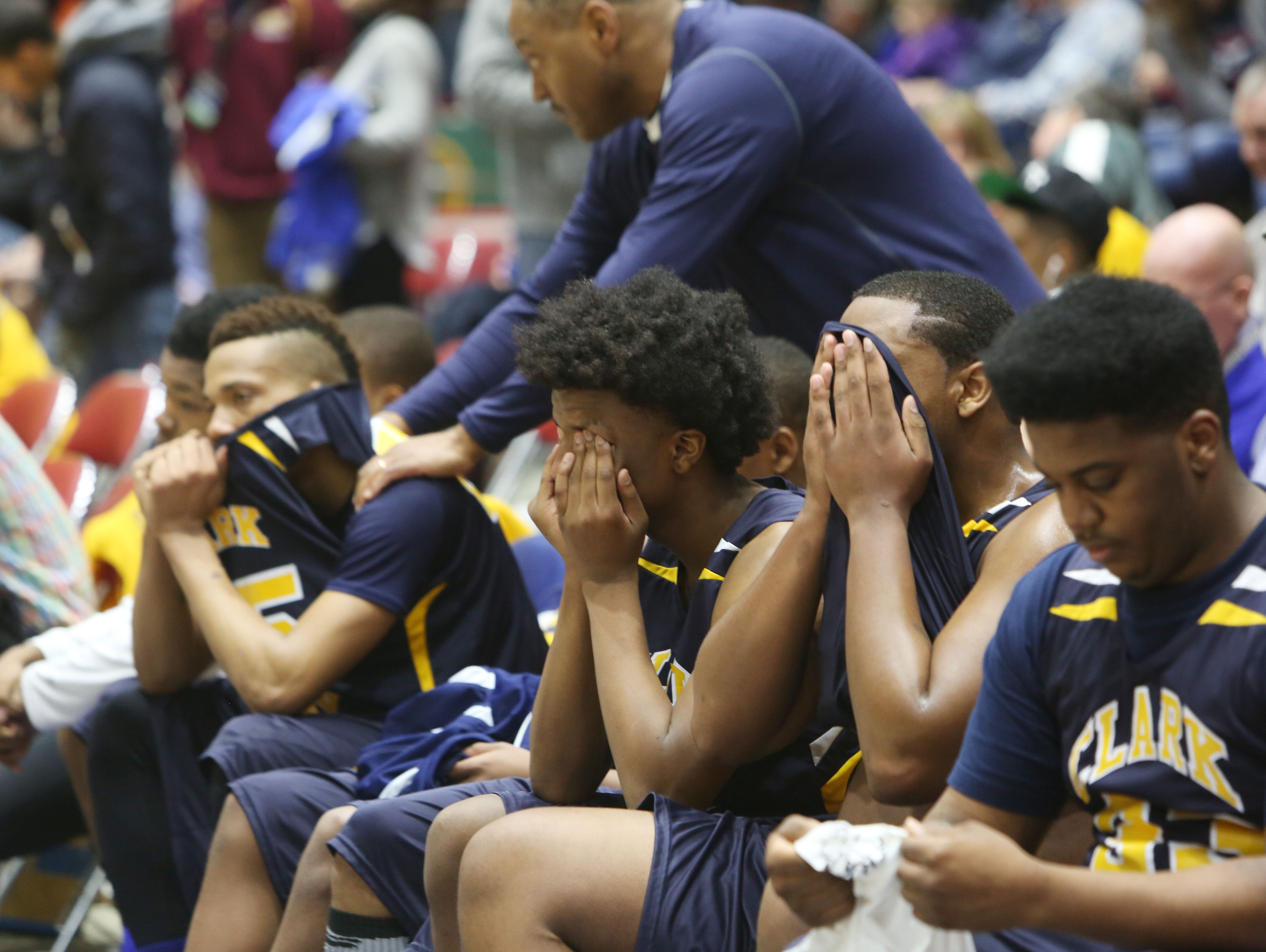 Clark Academy players watch from the bench as their season comes to an end against Oriskany in the boys Class D semifinal at the Glens Falls Civic Center March 11, 2016. Oriskany won the game 59-40.