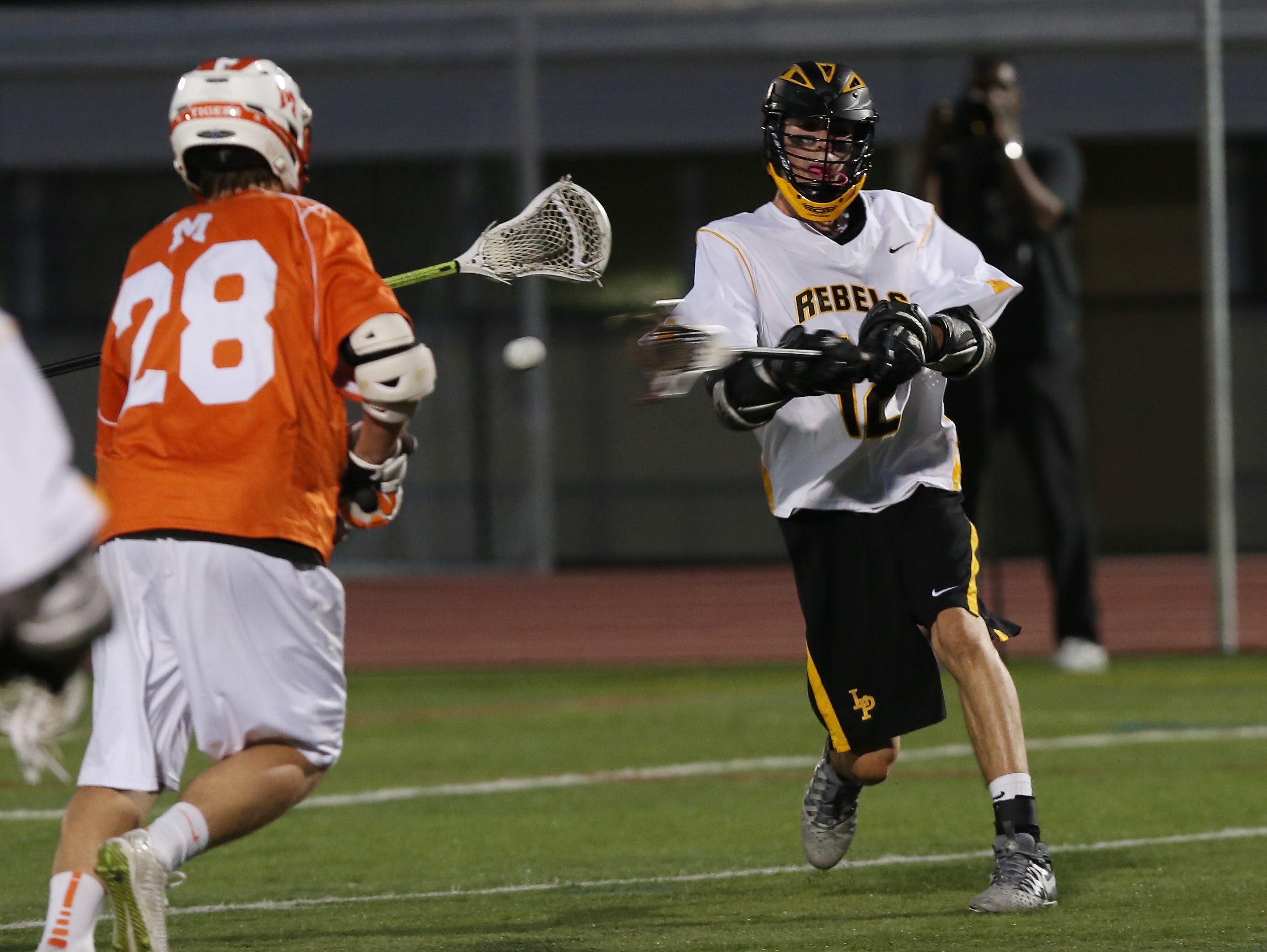 Lakeland/Panas' Drew Thompson (12) fires a shot in front of Mamaroneck's Se' McElroy (28) for a first half goal during the Section 1 championship game at White Plains High School May 25, 2016.