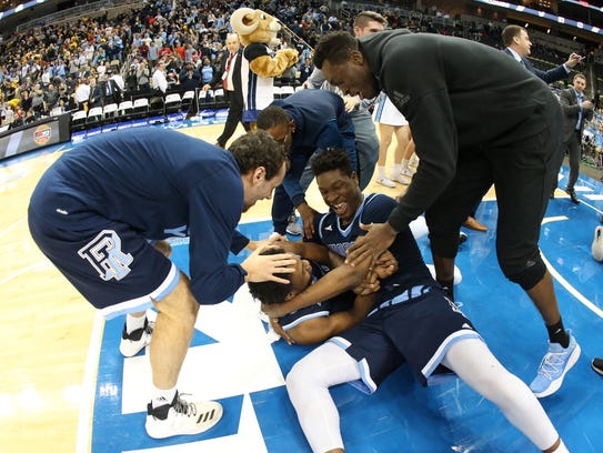 Rhode Island Rams players react after defeating the