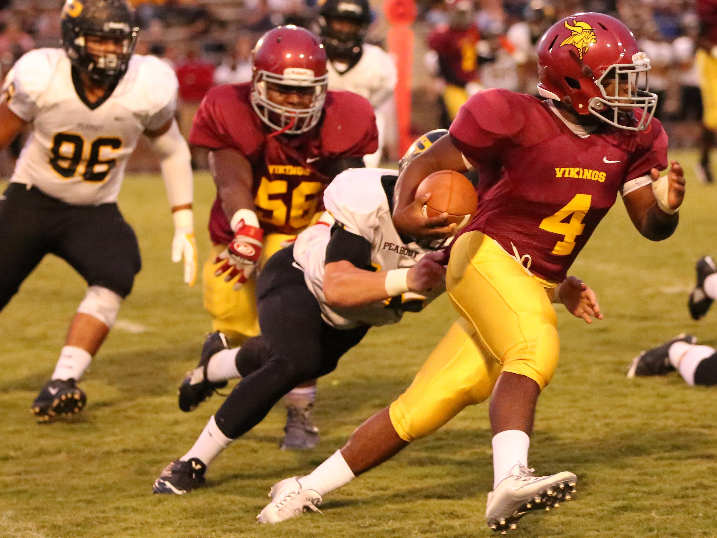 Humboldt's Jaylen Stewart runs around the end and shakes a Peabody tackle Friday night.
