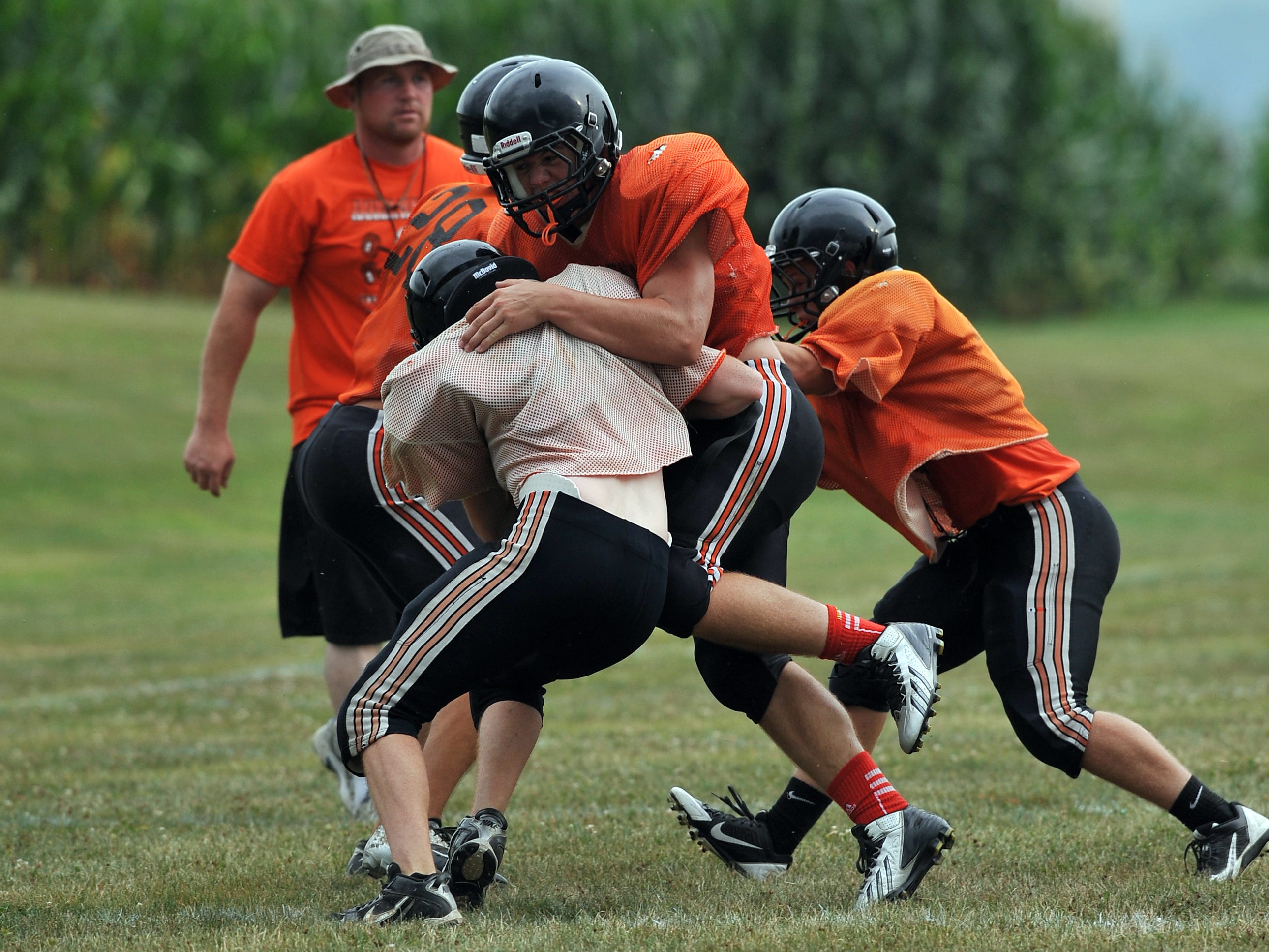  Amanda-Clearcreek senior Cole Genders blocks a teammate during a kickoff drill during an Aug. 6 practice in Amanda. 