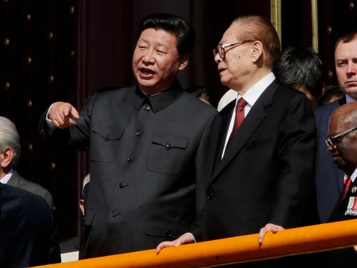 Chinese President Xi Jinping, left, talks with former
