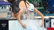 Natalie Adams of the United States splashes water on