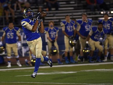 Reed's Michael Spivack hauls in a touchdown catch while taking on Carson during their game at Mackay Stadium in Reno on Aug. 29, 2015.