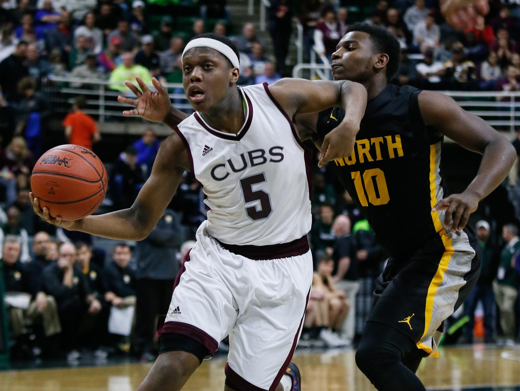 U-D Jesuit’s Cassius Winston drives the lane against North Farmington's Amauri Hardy on Saturday. This year’s Mr. Basketball winner turned in one of the greatest individual performances in state final history — 31 points, 14 for 16 shooting, nine assists — in the 69-49 win.