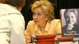 Sen. Hillary Clinton autographs copies of "Living History"
