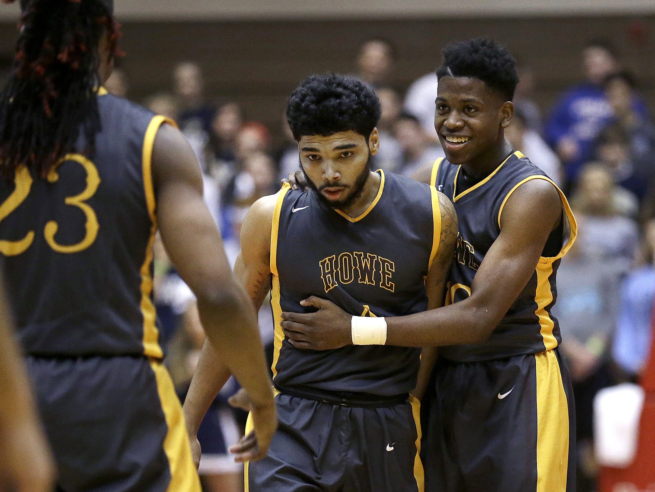 Howe's Rashawn Rush, right, begins to celebrate with Brian “Kip” Warren (center) as they defeated Providence in the IHSAA Class 2A semistate March 19, 2016.
