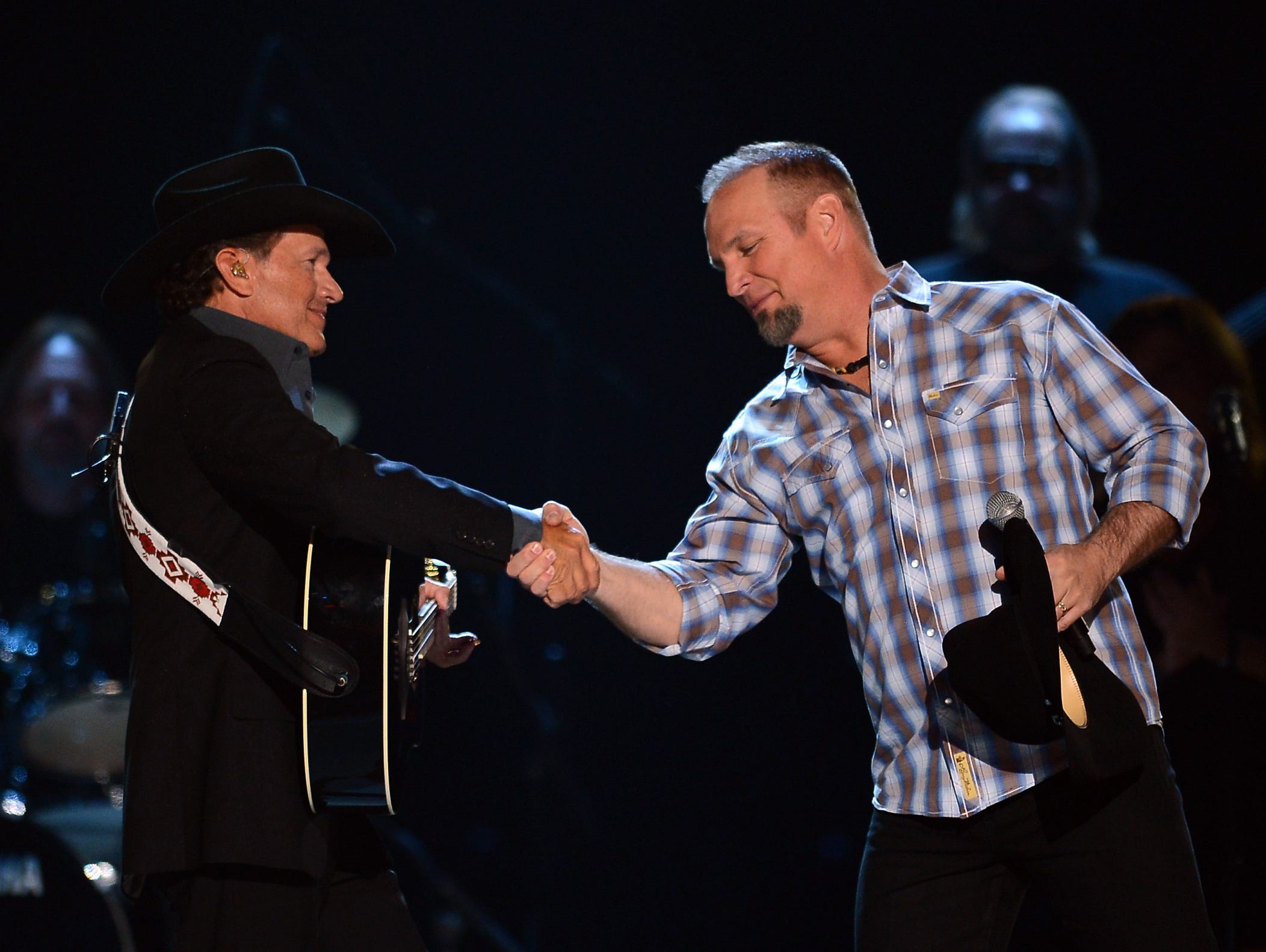 George Strait (L) and Garth Brooks perform onstage during the 48th Annual Academy of Country Music Awards at the MGM Grand Garden Arena on April 7, 2013 in Las Vegas.