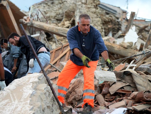 Rescuers clear debris while searching for victims in