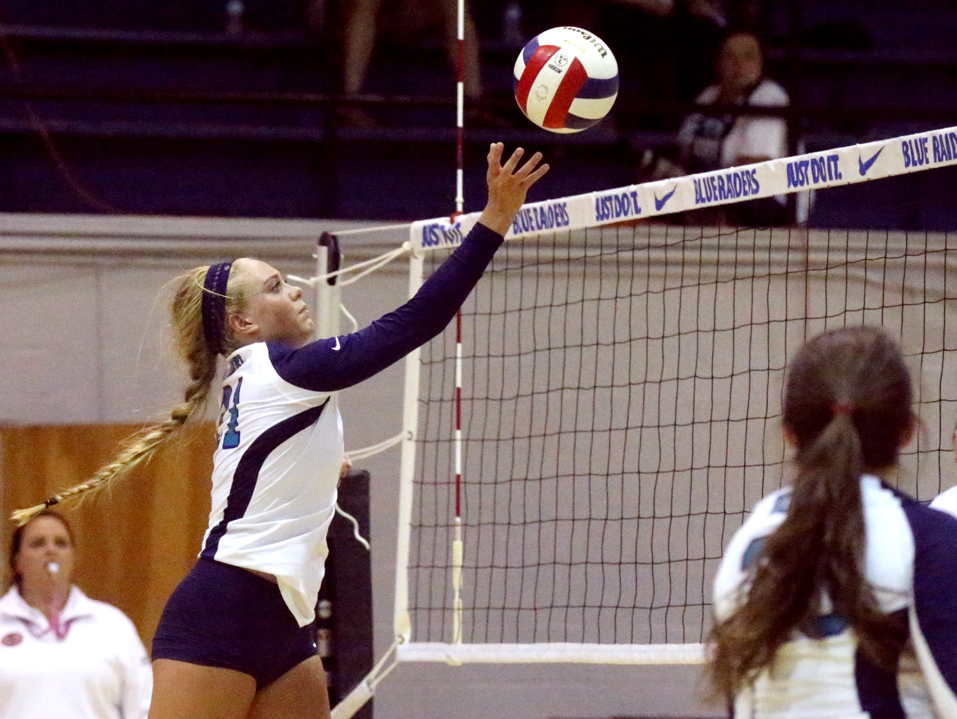 Siegel's Leah Poarch (21) hits the ball over the net during the second round of the TSSAA Class AAA state volleyball tournament against Bearden Wednesday at MTSU.