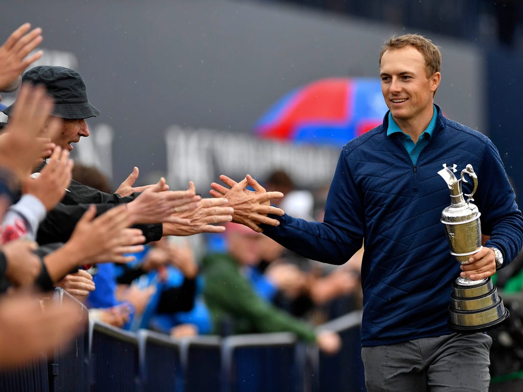Jordan Spieth greets fans after winning the 146th Open Championship golf tournament at Royal Birkdale Golf Club in Southport, England.