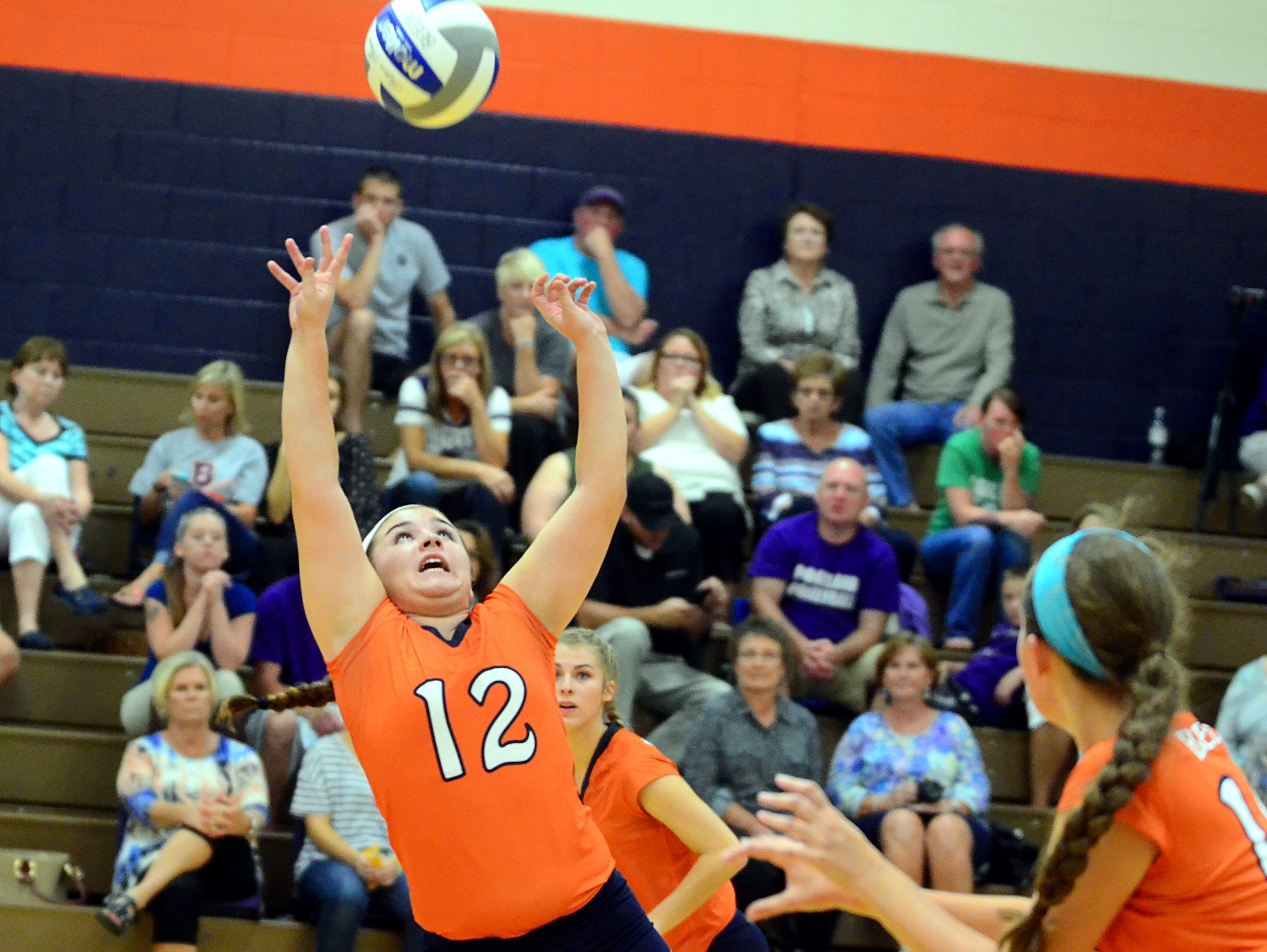 Beech senior Reeves Parrish controls a set as she falls during Tuesday’s match against Portland. The Lady Buccaneers won in five sets.