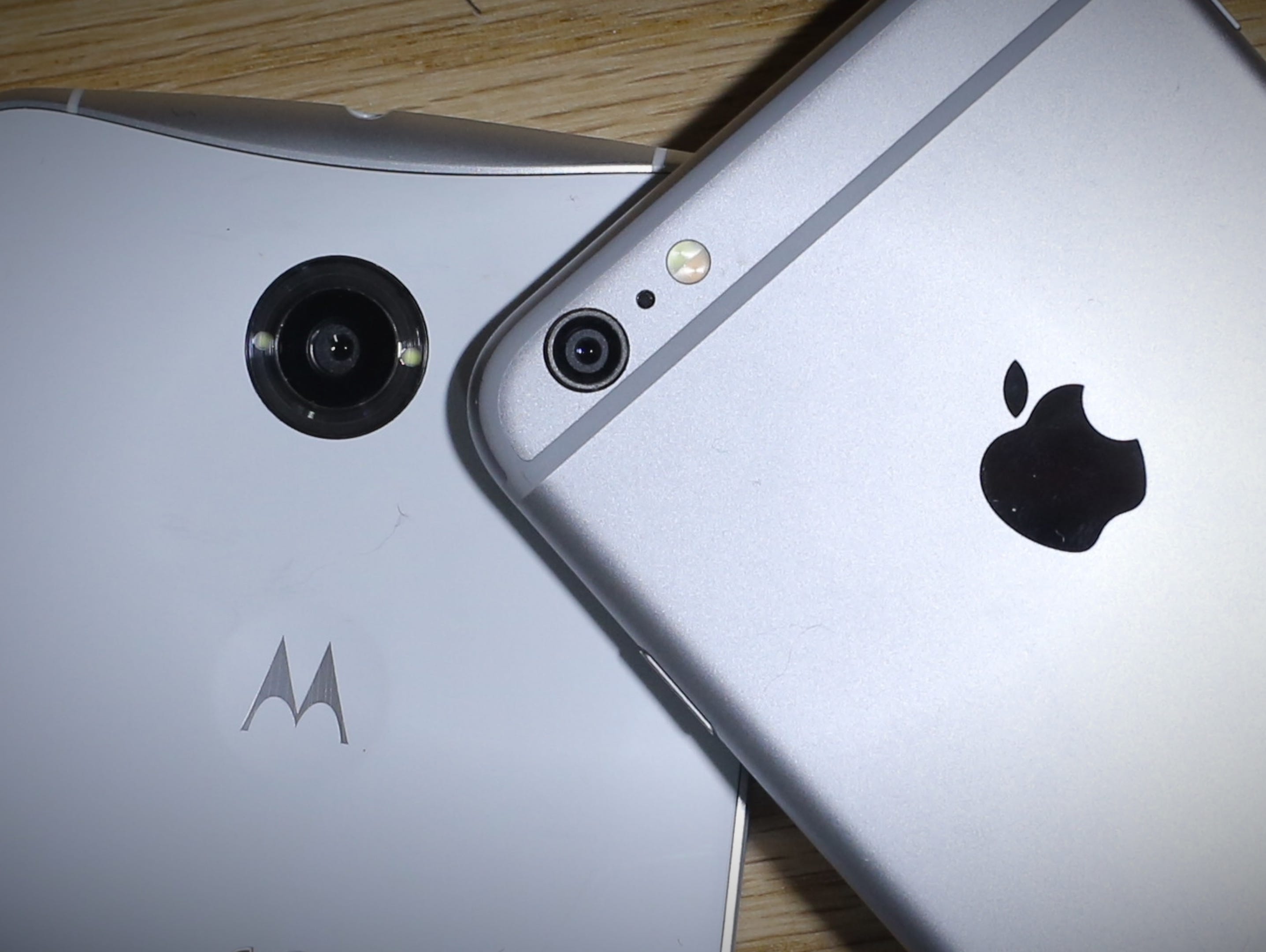 The back views of the Google Nexus 6 (made by Motorola) and the Apple iPhone 6 Plus.