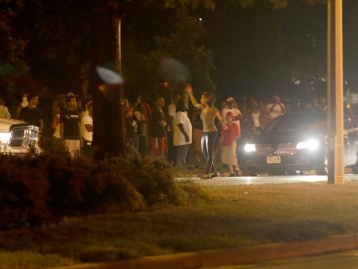 A crowd gathers near N. Sherman Blvd. north of W.