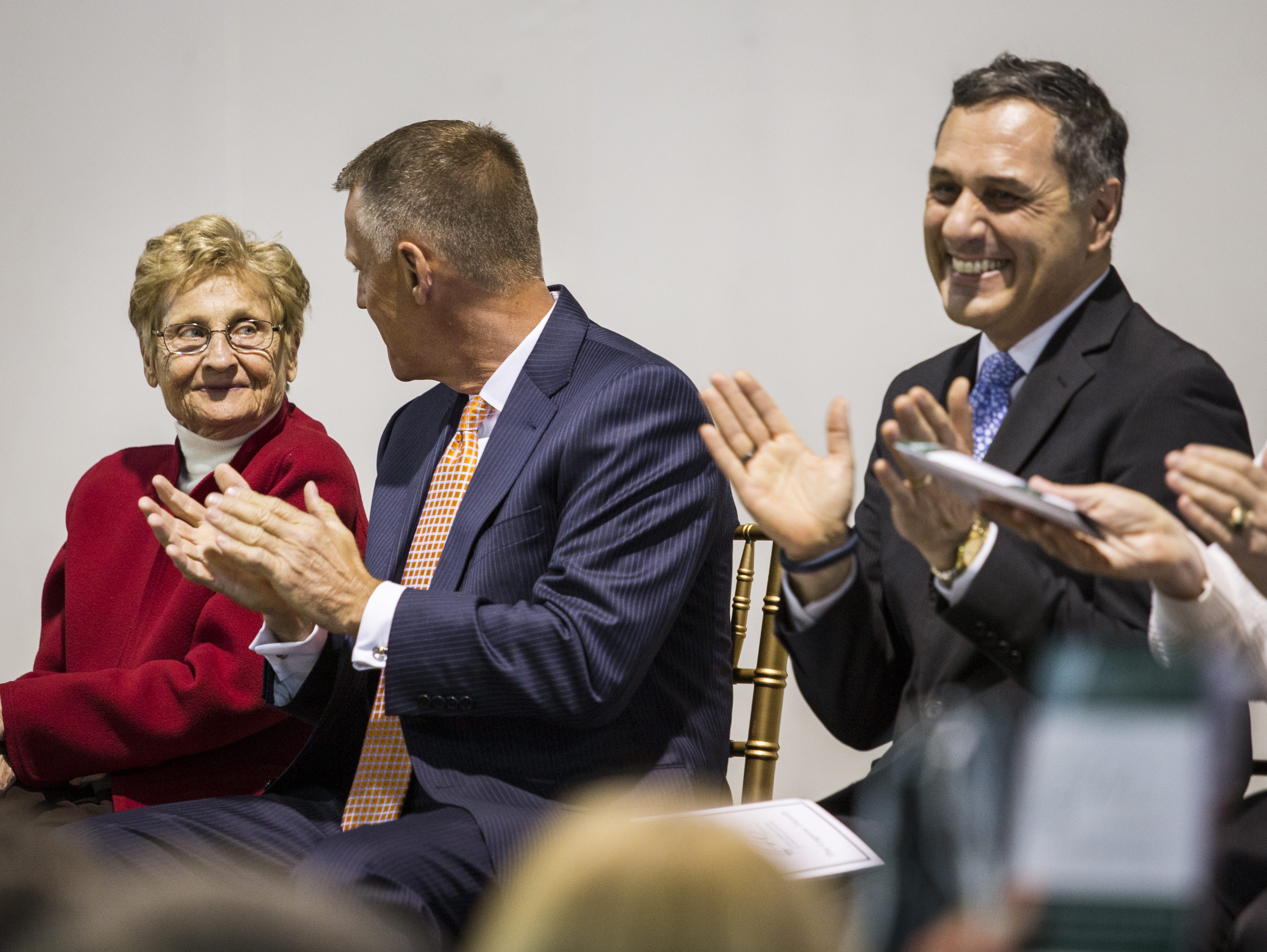 Marcy Aitken looks to her son Mark as she's applauded at a ceremony honoring Aitken for her contributions to Archmere on Thursday evening.