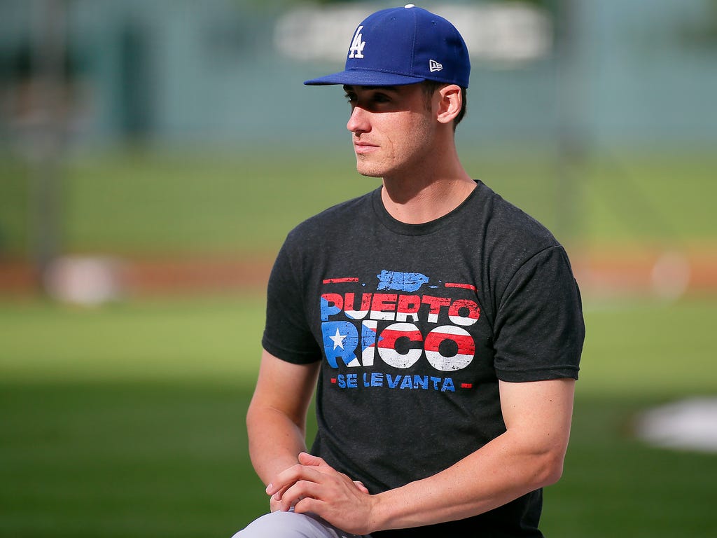 Los Angeles Dodgers infielder Cody Bellinger (35) wears a shirt in support of Puerto Rico during batting practice prior to a game against the Colorado Rockies at Coors Field.