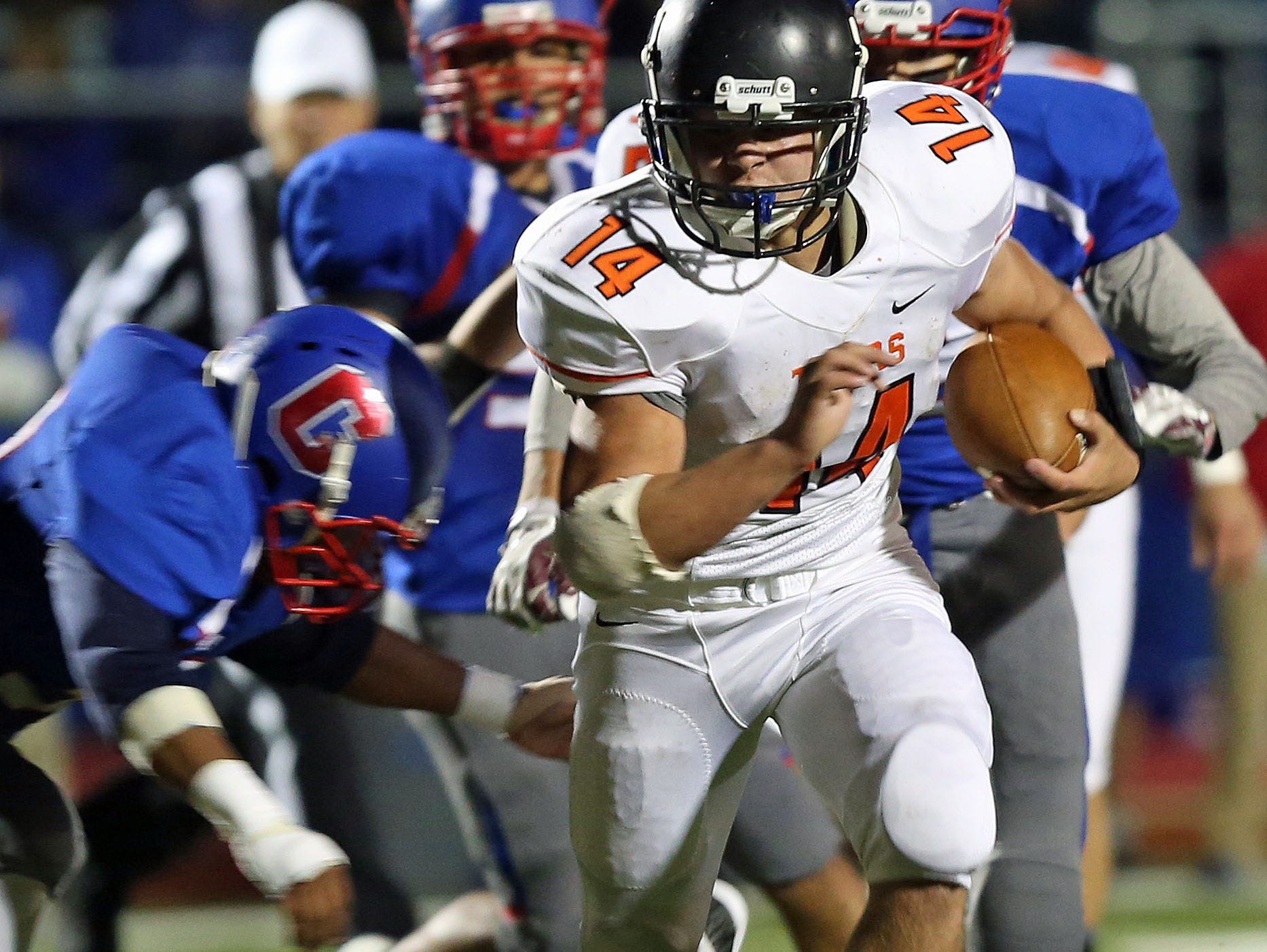 Mamaroneck's Daniel O'Rourke (14) finds some running room in the Carmel defense after a first half catch and run during a boys football playoff game at Carmel High School Oct. 16, 2015.