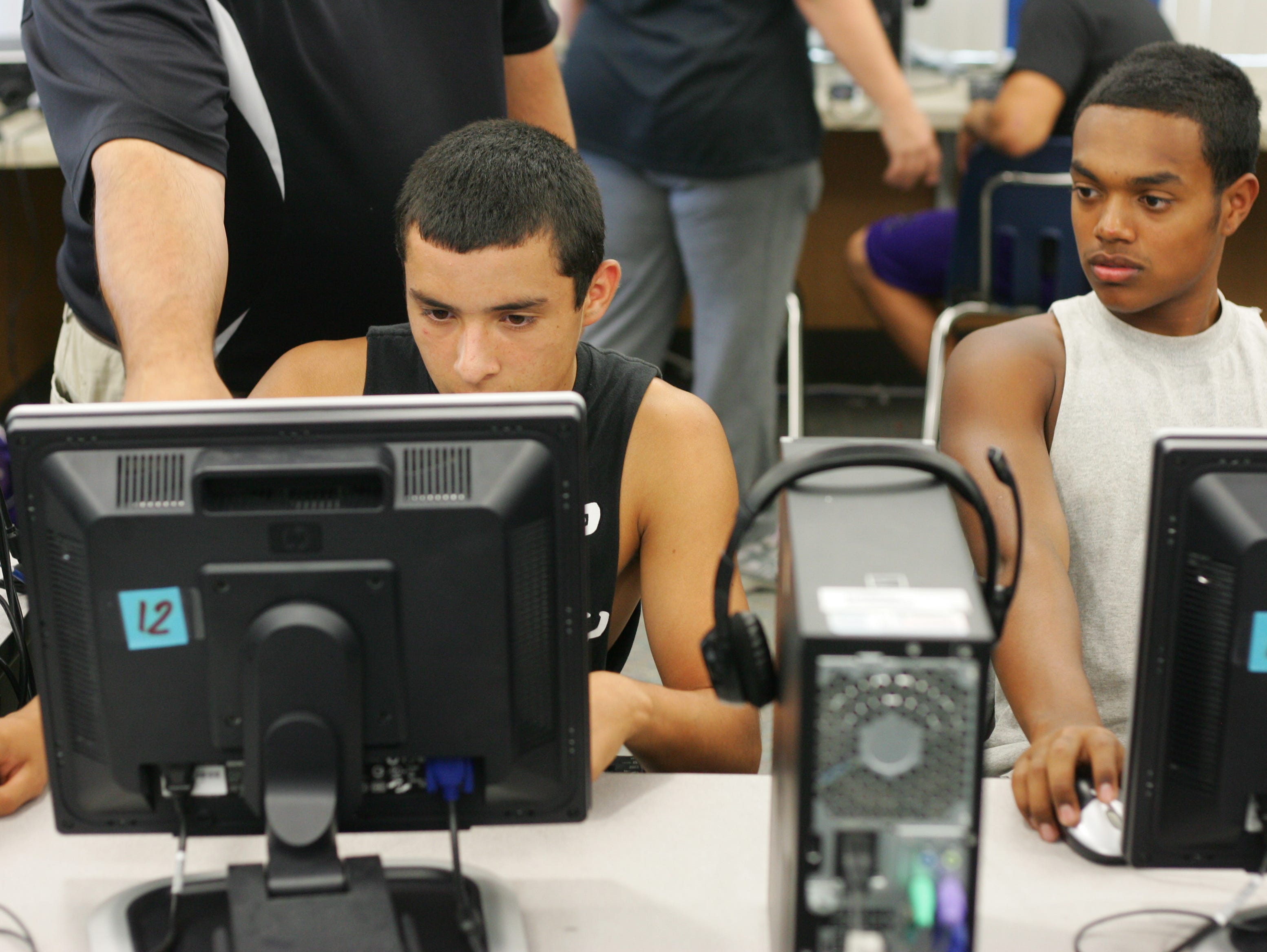 In this 2012 file photo, members of the Shadow Hills High School varsity football team prepare to take an ImPACT test, a computer based test to set a baseline for the cognitive ability of the test taker. After a concussion the athlete can retake the test to see if his or her cognitive skills have suffered.