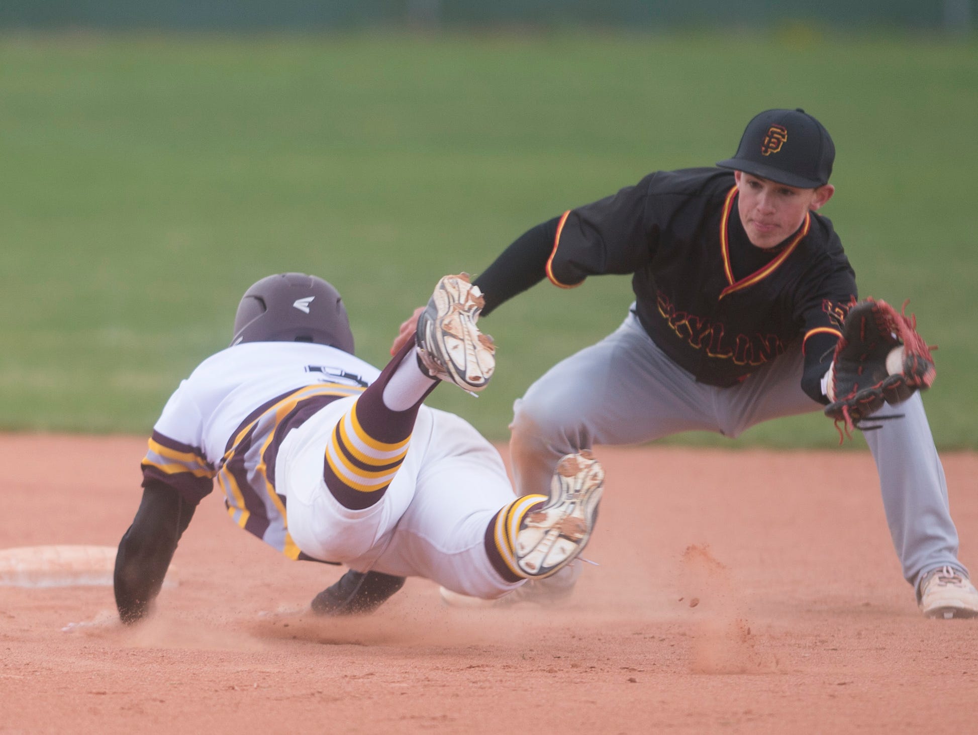 Windsor outfielder Jaden Traut slides into second base during a game against Skyline High School in Windsor Friday.