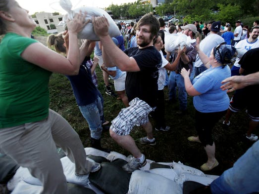 Volunteers help move sandbags at MetroCenter as the