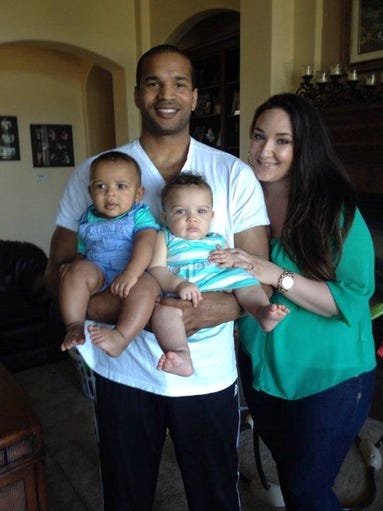 Kenika Ng (L) holds hold twins Dennis (L) and Viviana (R) while standing next to his wife Ashley Ng as they pose for a photo. Ashley Ng shared this with News10 on Wednesday, Oct. 30, 2014.