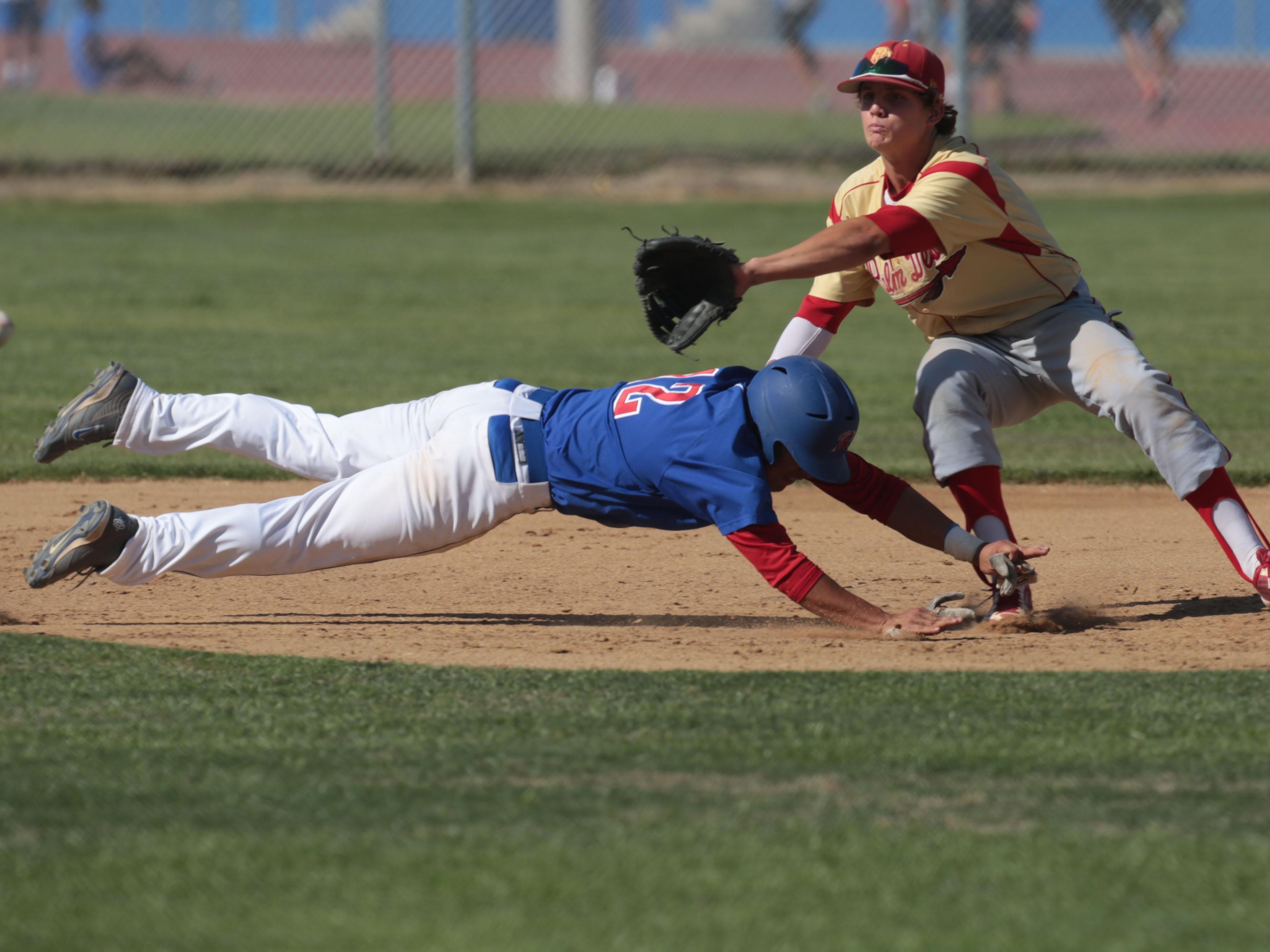 Indio’s Jonathan Diaz dives safely back on to second as the ball reaches Palm Desert’s Travis Moniot on Tuesday, April 15, 2014 in Indio.