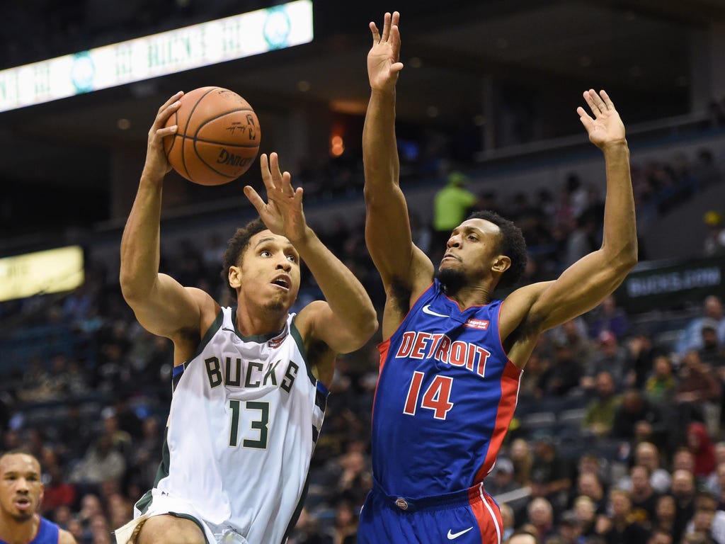 Milwaukee Bucks guard Malcolm Brogdon takes a shot against Detroit Pistons guard Ish Smith in the first quarter at BMO Harris Bradley Center in Milwaukee.