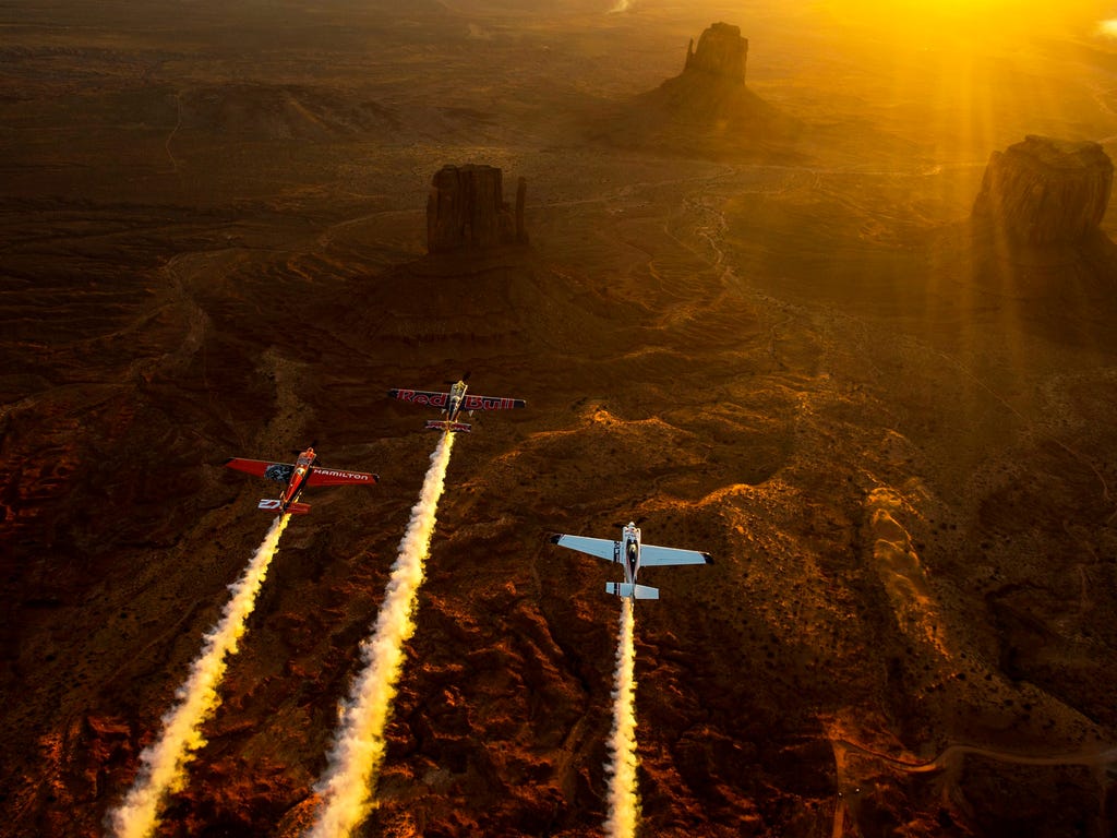 Kirby Chambliss, Nicolas Ivanoff and Matthias Dolderer fly over the Monument Valley Navajo Tribal Park in Utah as the three pilots ferry their race planes to the season finale of the Red Bull Air Race World Championship held in Las Vegas.