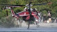 A Helicopter Transport Services aircraft gathers water