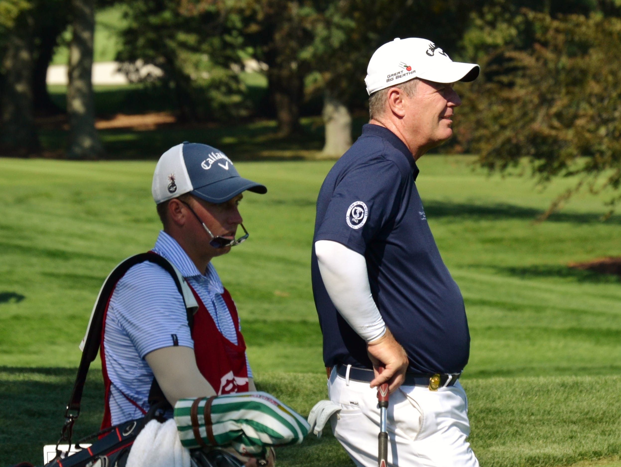 Met Open champion Mark Brown waits to tee off Wednesday at the 17th hole at Glen Oaks with caddie Josh Rackley. The Tam O'Shanter head pro also won the Met Open in 1999 and 2013.