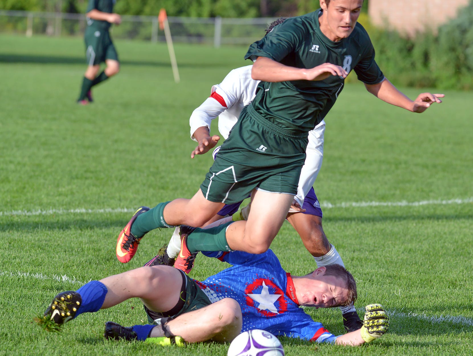 Pennfield goalkeeper Keith Browand slides for the ball during game action Wednesday night.