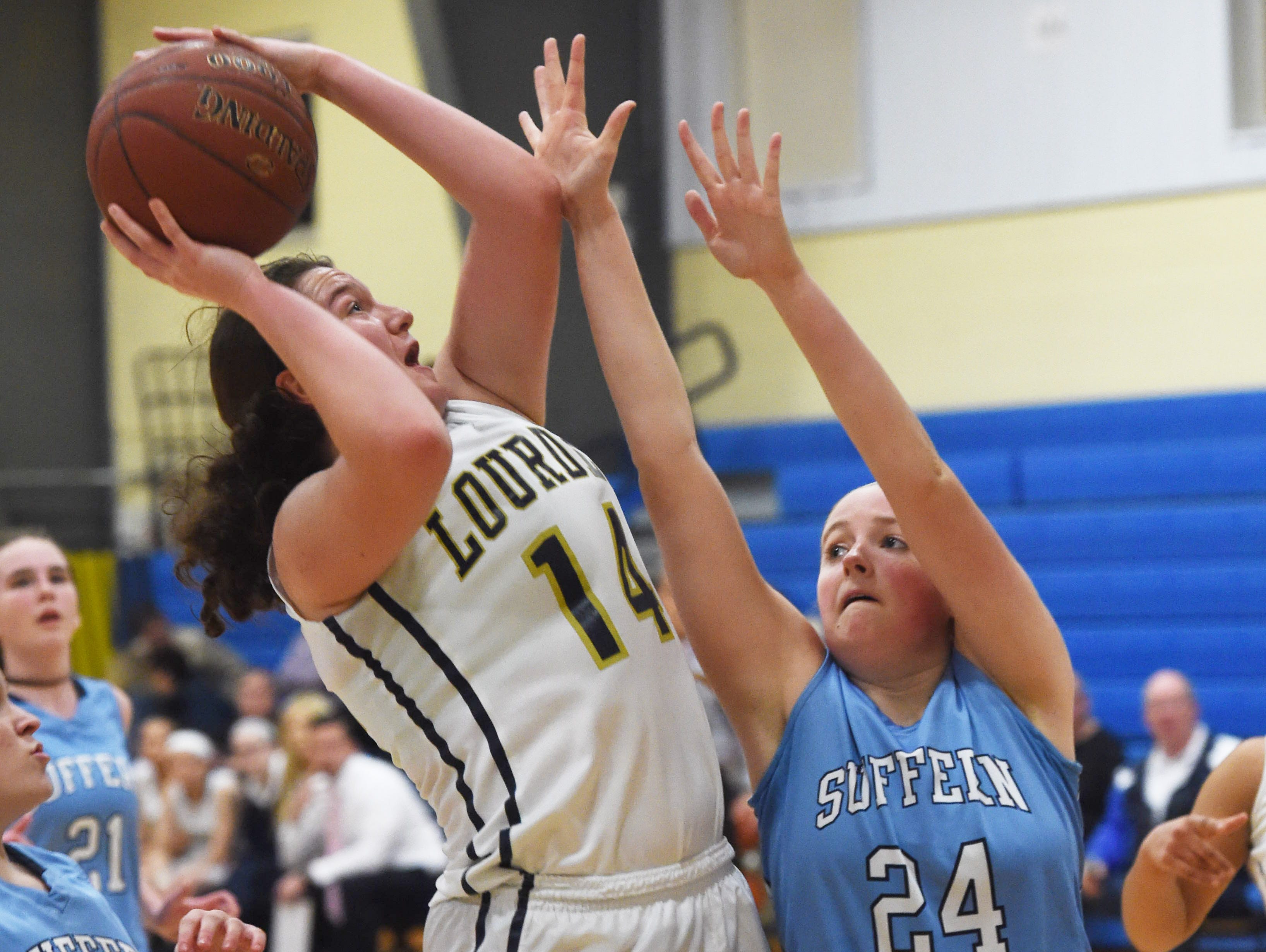 Lourdes' Abby Weeks, left, goes for a shot as Suffern's Caleigh Calhoon, right, defends during Friday's game.