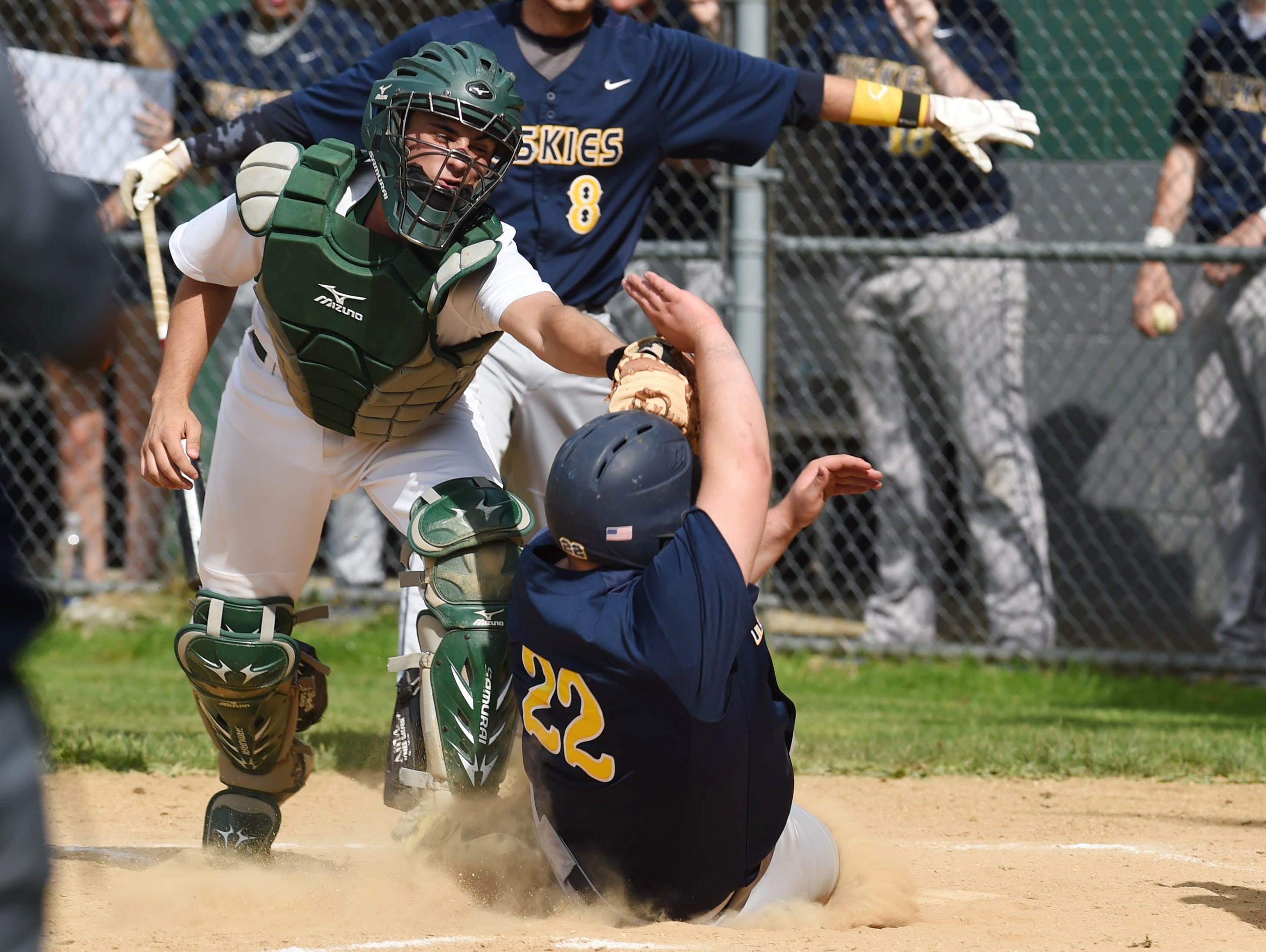 Spackenkill's Joe Arcuri, left, tags out Highland's Frank Alfonso, right, at home plate during Monday's game.