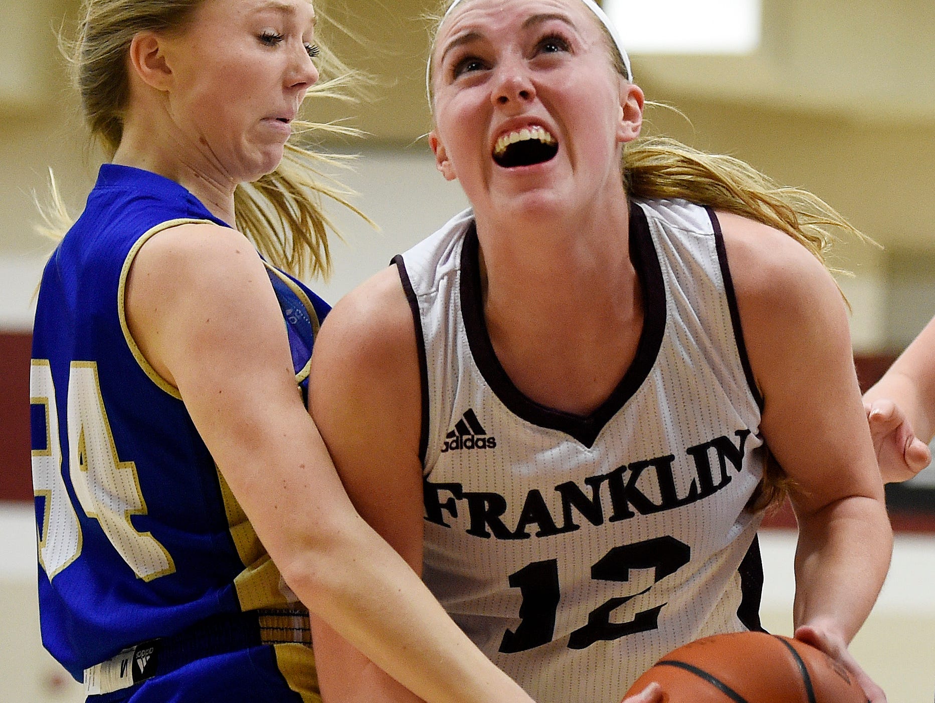 Franklin's Holly Harris (12) drives into Brentwood's Morgan Mevak (34) during the first half at Franklin High School, Tuesday, Feb. 16, 2016, in Franklin, Tenn.