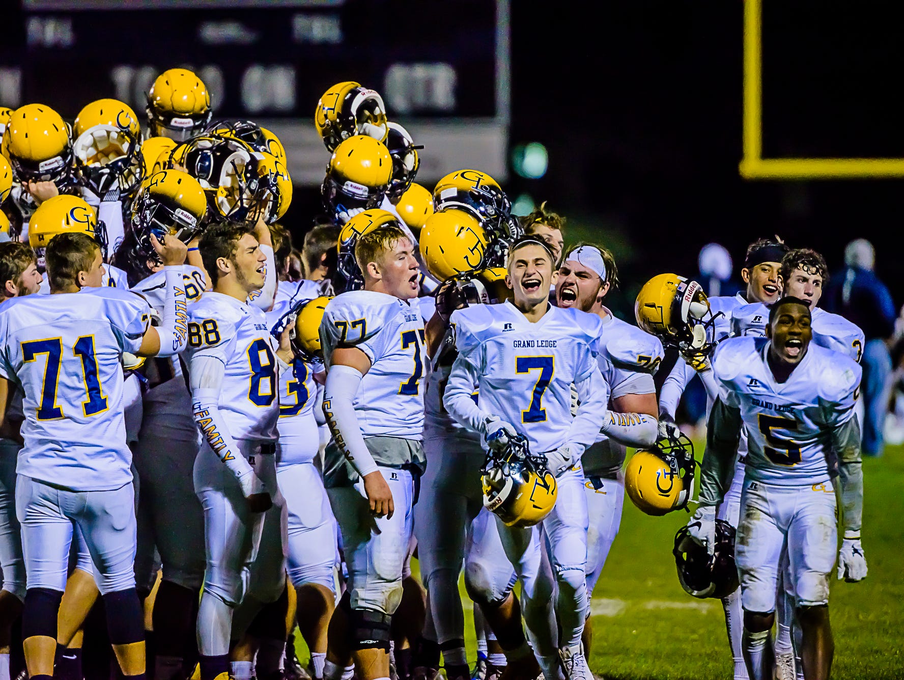 Members of the Grand Ledge football team celebrate after their 31-28 win over East Lansing Friday October 14, 2016 in East Lansing.