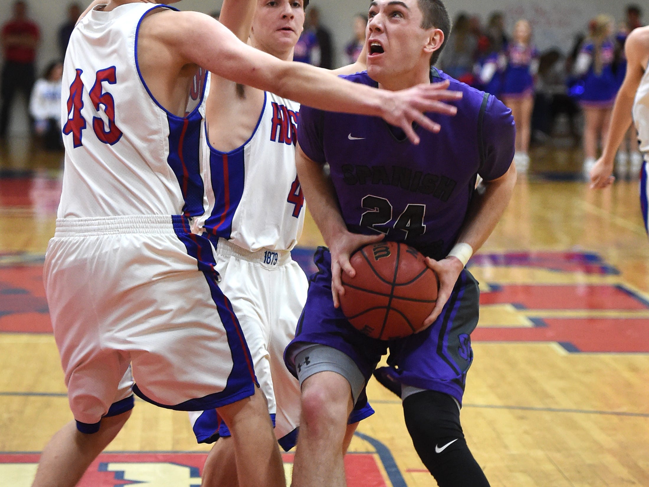 Spanish Springs' Josh Prizina looks to shoot with Reno's Thomas Beach (45) and Kyle Rose (4) guarding him on Feb. 7. Spanish Springs hosts Douglas on Tuesday and Carson is at Reno in quarterfinal games of the Northern 4A Regional tournament.
