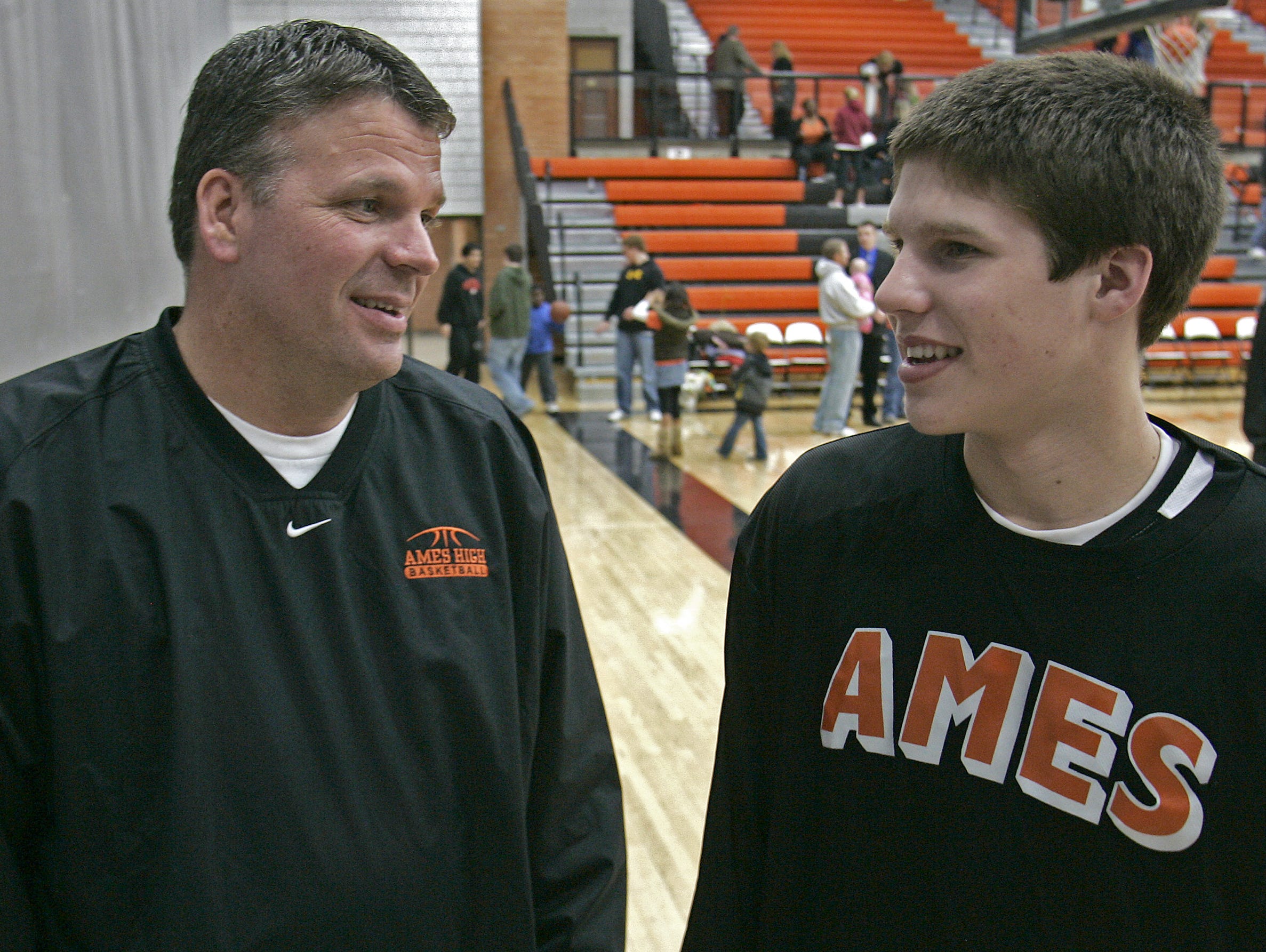 Former Iowa State head men's basketball coach Greg McDermott, left, talked with his son, former Ames High School basketball player Doug McDermott, after Doug scored 18 points in a win over Ft. Dodge on Feb. 12, 2009.