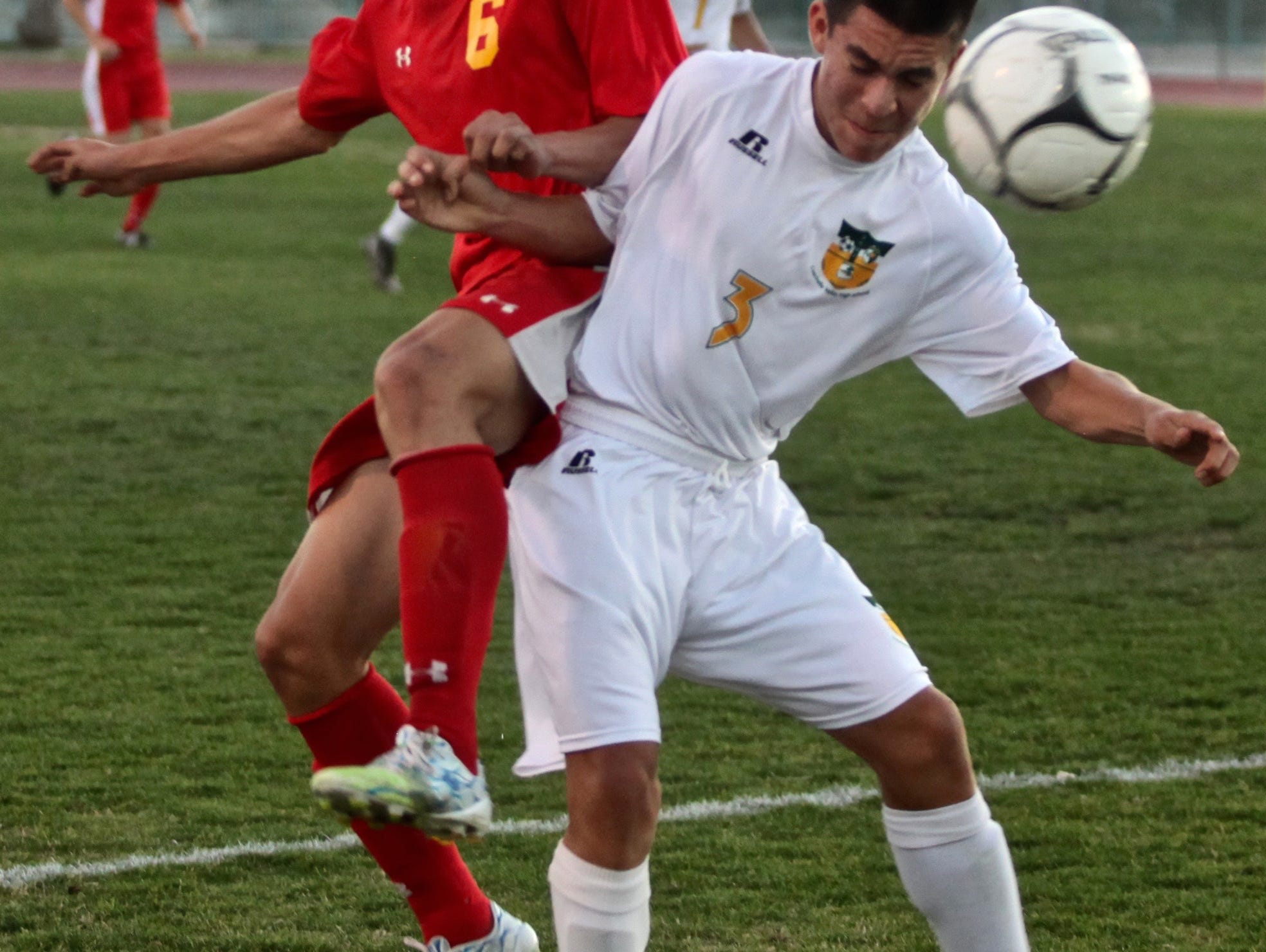 Palm Desert's Gerardo Serrano (6) and Coachella Valley's Oscar Cervantes (3) battle for the ball during a match in Thermal on Tuesday.